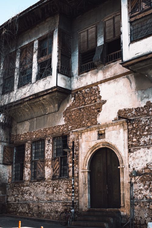 Free Explore the rustic charm of this historic Ottoman building facade in Antalya, showcasing beautiful architectural details. Stock Photo