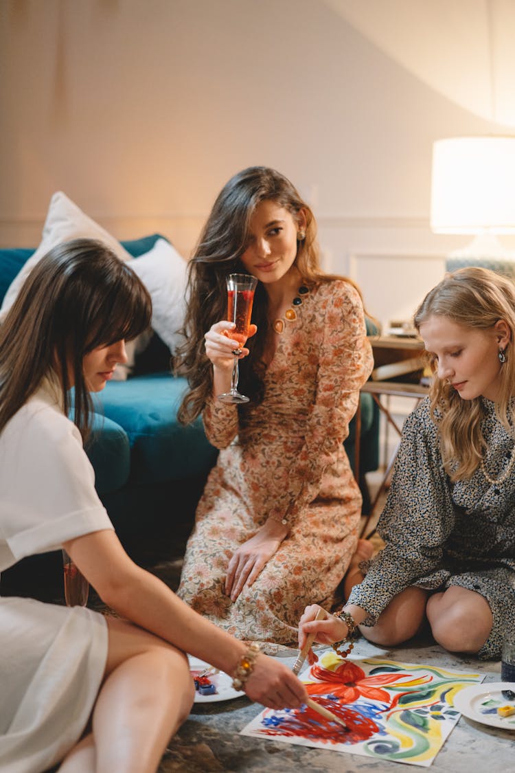 Women Sitting Painting And Drinking Champagne 