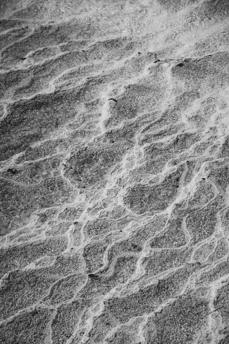 Grayscale Photo Of Sand With Wind Marks