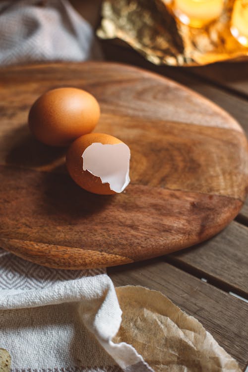 Chicken Egg and an Eggshell on a Cutting Board