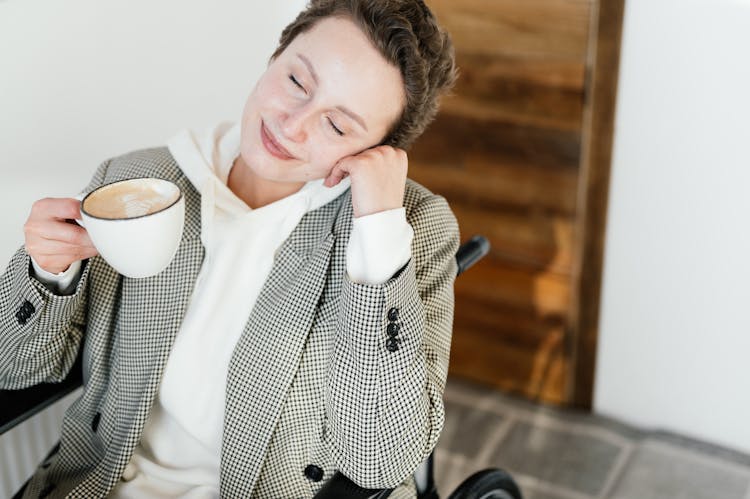 Peaceful Woman On Wheelchair With Coffee