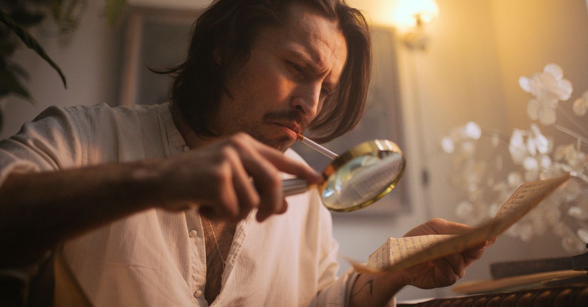 Person holding a dropped piece of toast, looking conflicted, with a magnifying glass over the floor