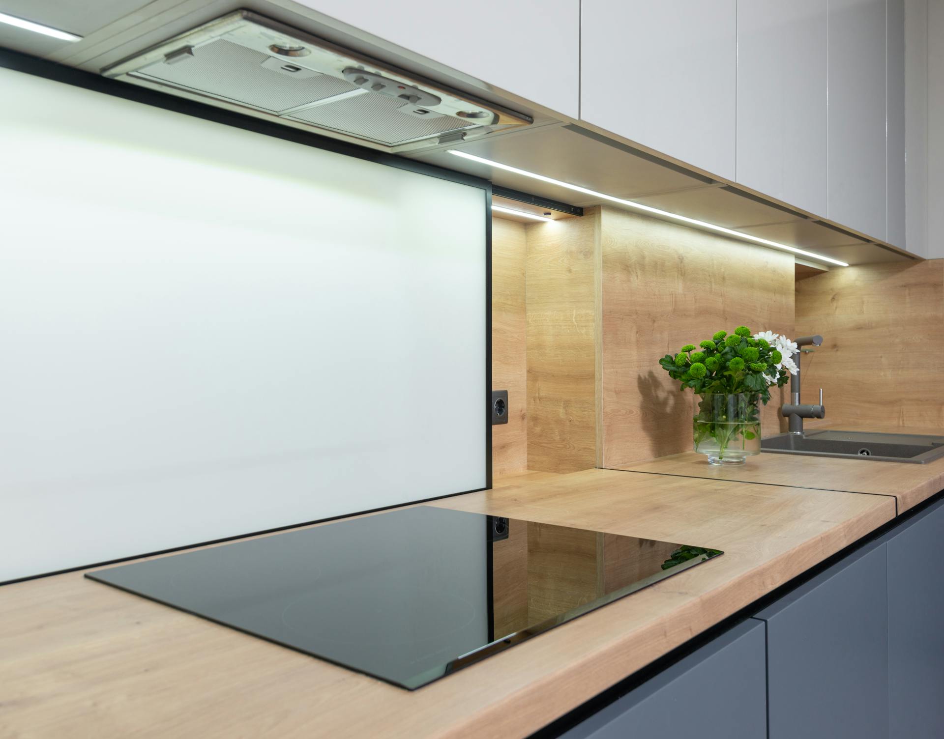 Stove under hood in modern kitchen at home