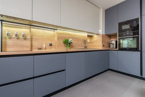 Contemporary kitchen interior with furniture and built in electric appliances