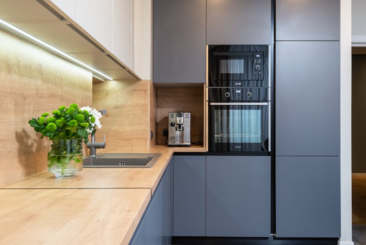 Modern Kitchen Interior With Cabinets And Electric Appliances At Home