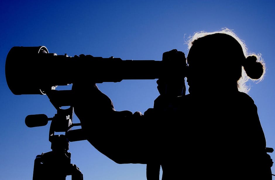 Man Looking at Telescope during Daytime