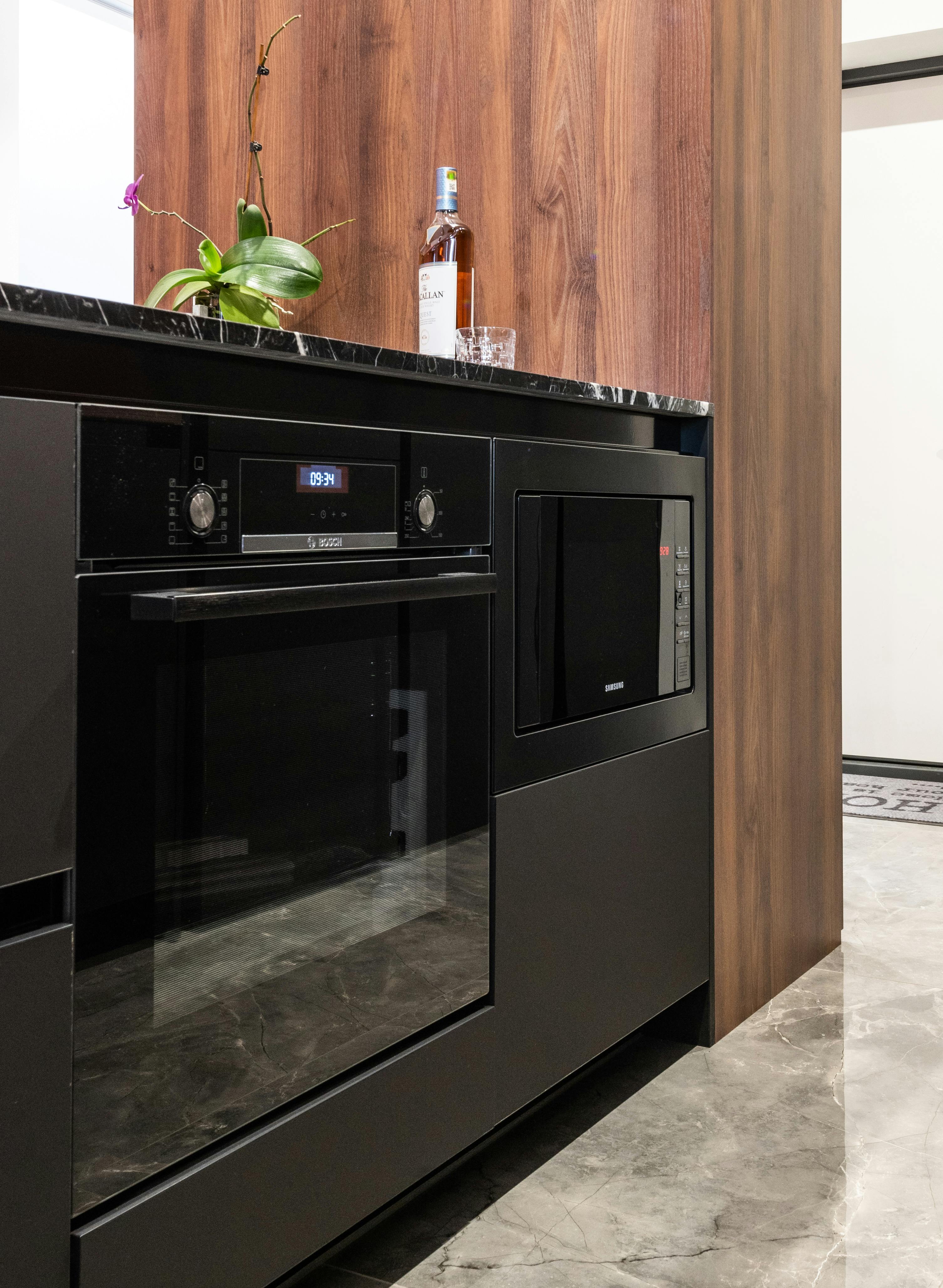 Vertical Image Of Modern Kitchen With Microwave Oven At Office For
