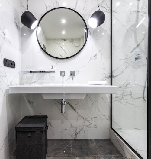 Modern bathroom interior with mirror above washbasin at home