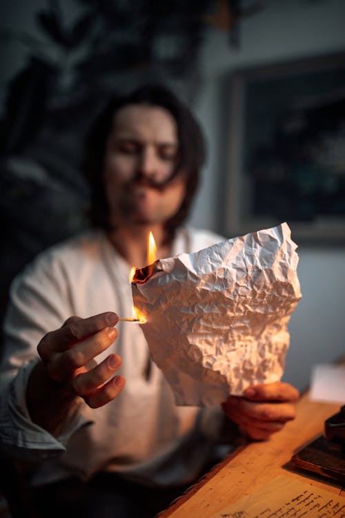 A Person Burning a Piece of Crumpled Paper