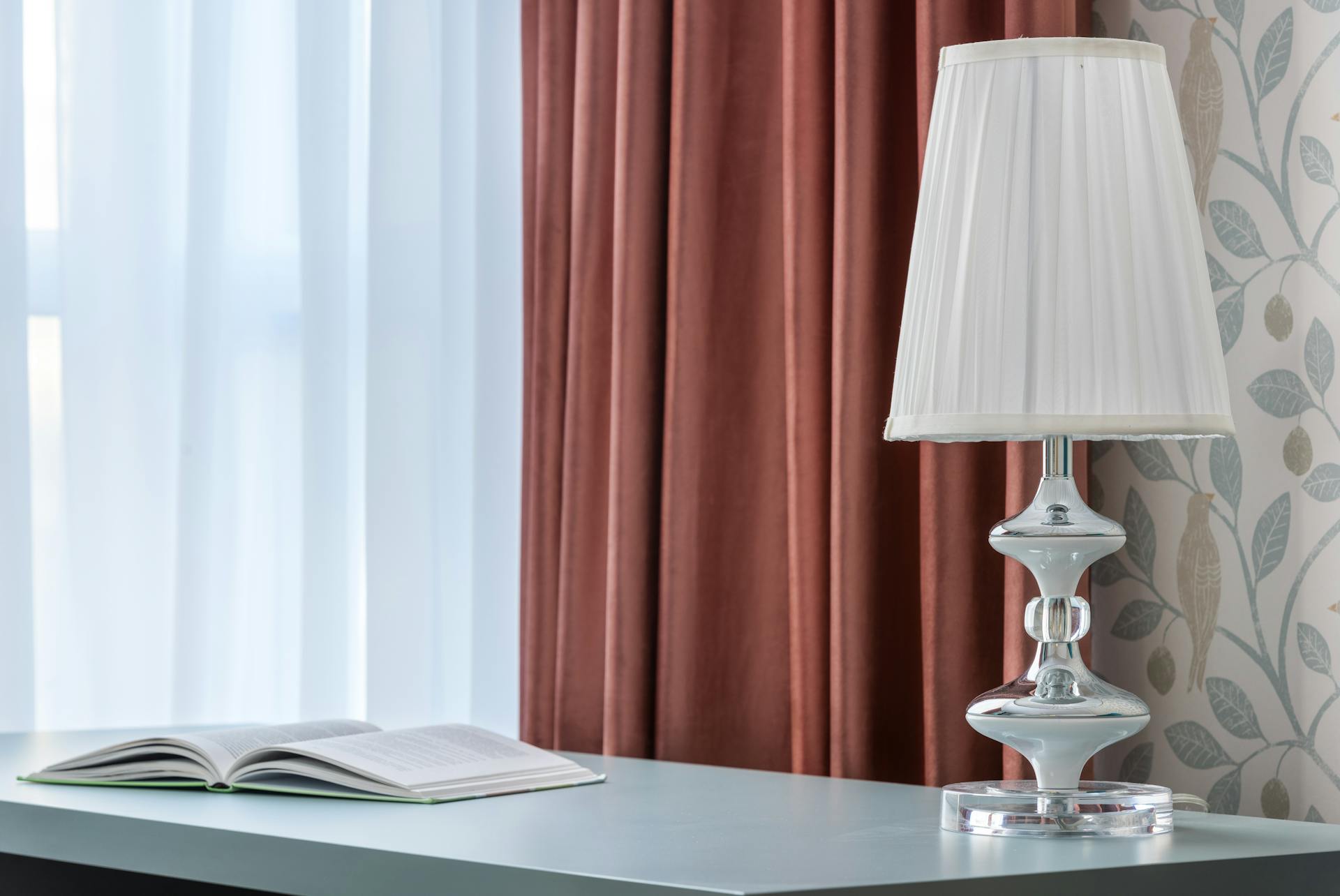 Lamp and book on desk in modern room