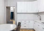 Modern kitchen interior with cabinets against table at home