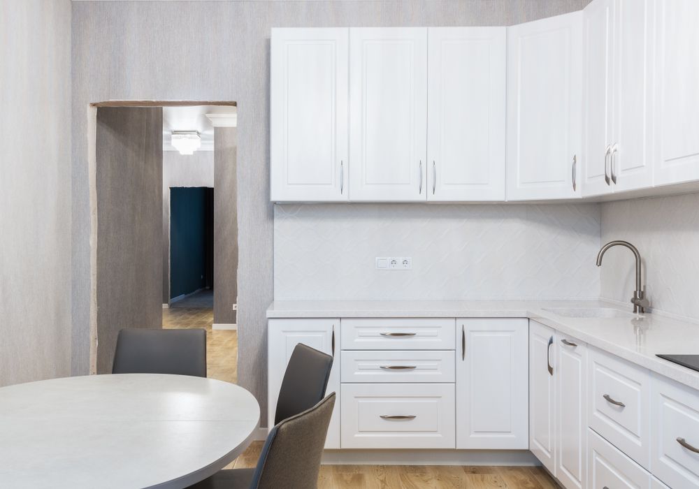 Bright contemporary kitchen with cabinets and dining area