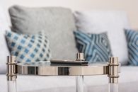 Metal table against sofa in modern room at home