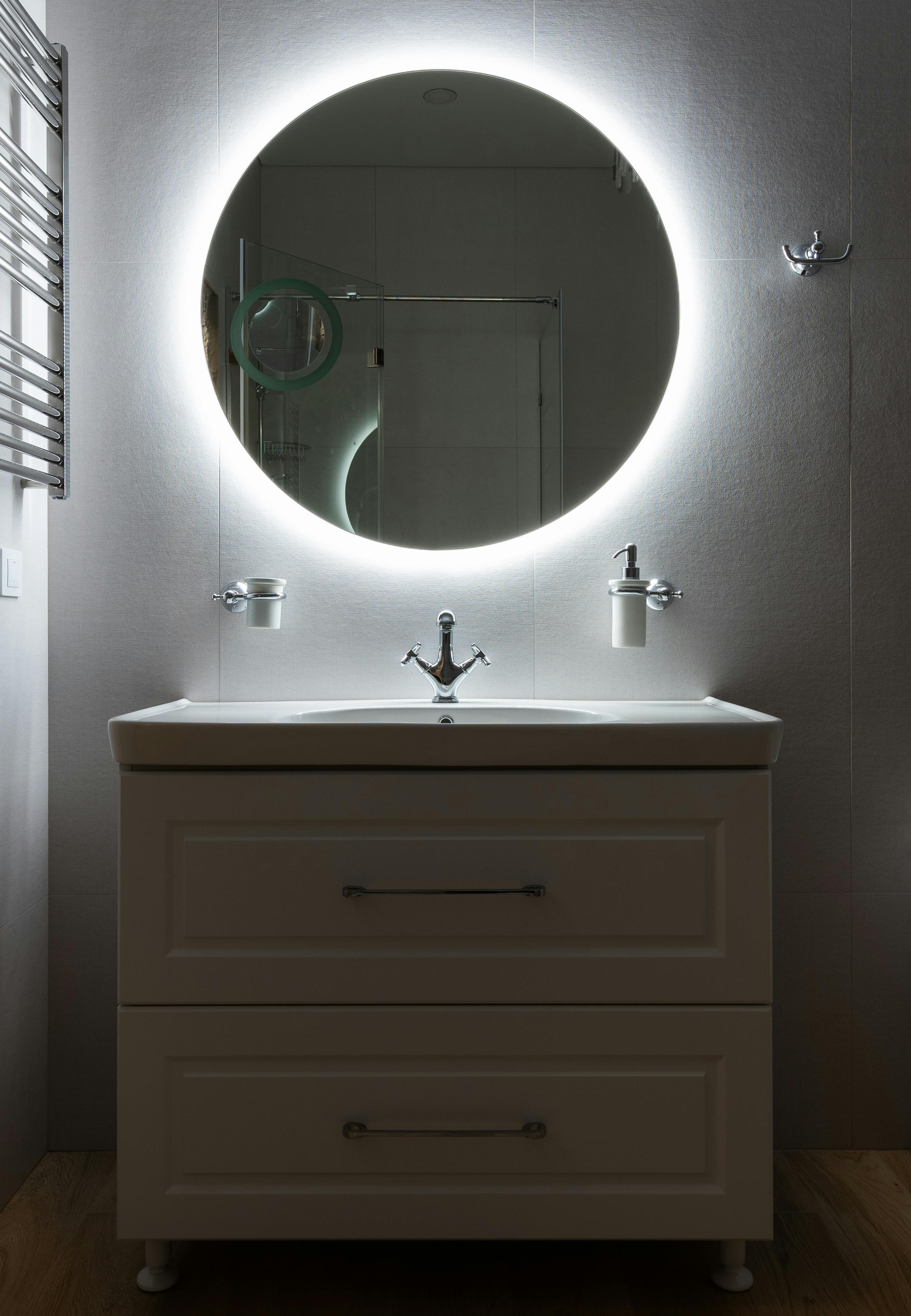 contemporary bathroom interior with cabinet under mirror at home