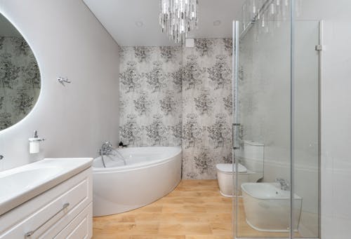 Modern bathroom interior with bathtub against toilet bowl