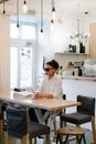 A Woman In White Long Sleeve Shirt Sitting on the Table