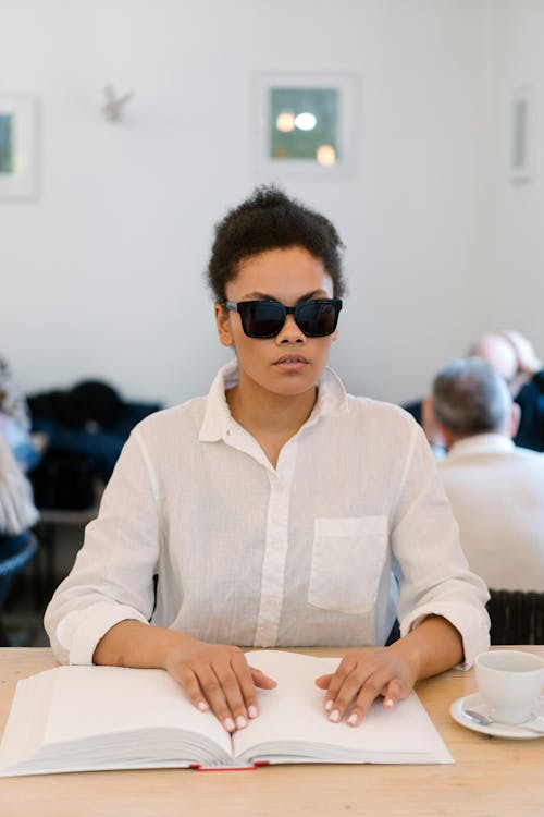 A Woman Touching a Impaired Book Page