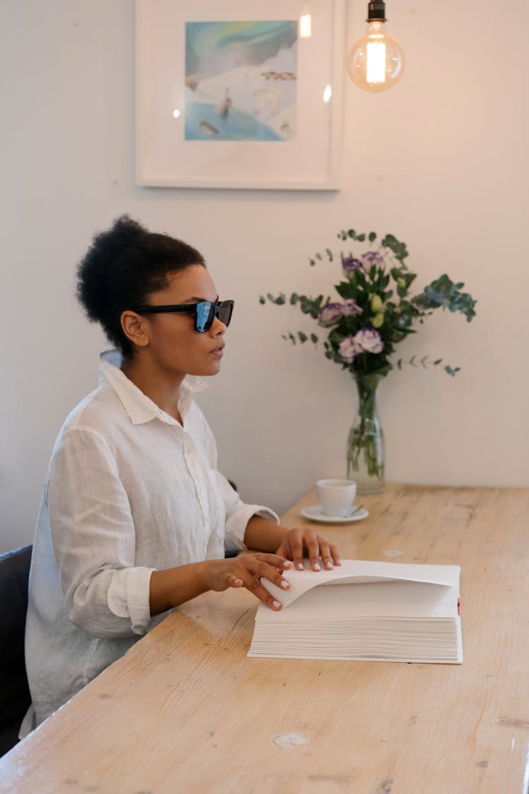 A Woman Touching A Braille Book 