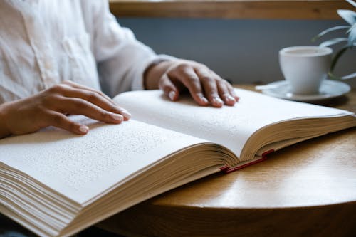 A Person Touching a Braille Book 