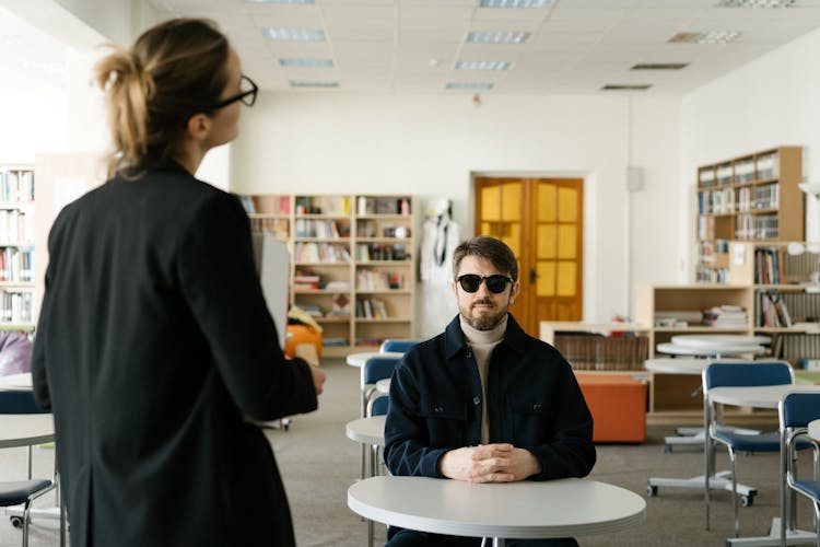 A Blind Man Sitting In A Class