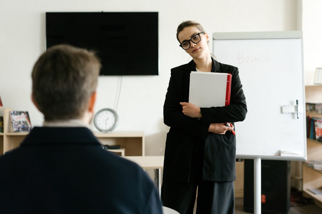 Woman in Black Blazer Holding White Paper