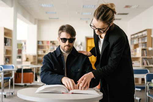 Free Man in Black Jacket Wearing Black Sunglasses with a Woman Stock Photo