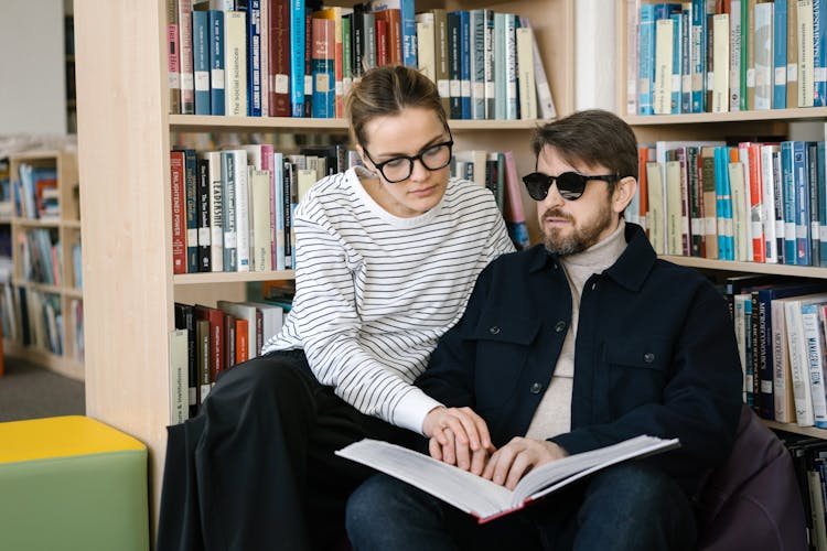 A Woman Helping A Blind Man 