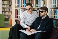Woman in Black and White Striped Long Sleeve Shirt Beside a Man
