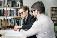 Woman Placing Man's Hand on a Book