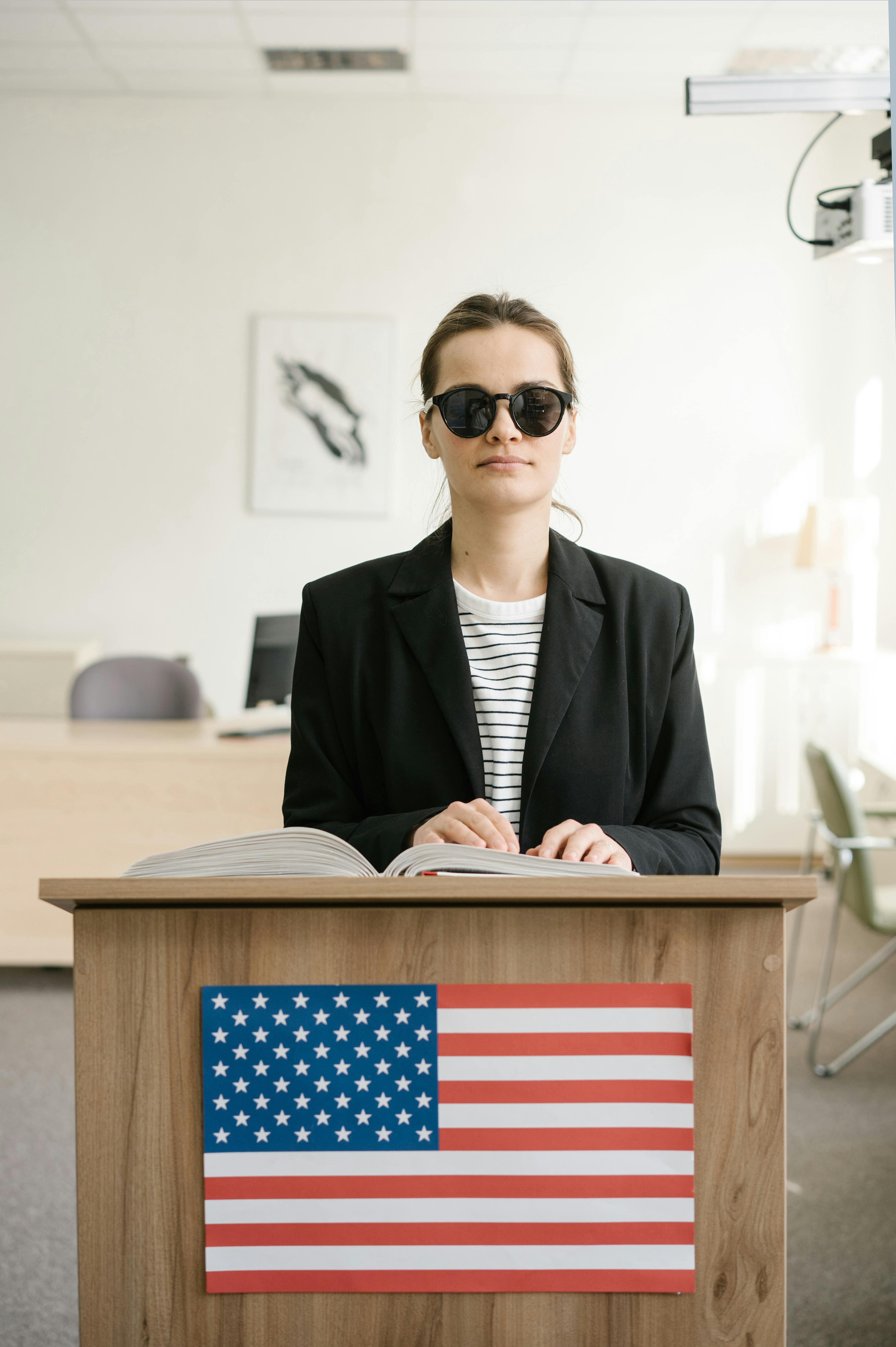 man in black suit jacket wearing black sunglasses