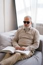 Photo of Elderly Man using Braille