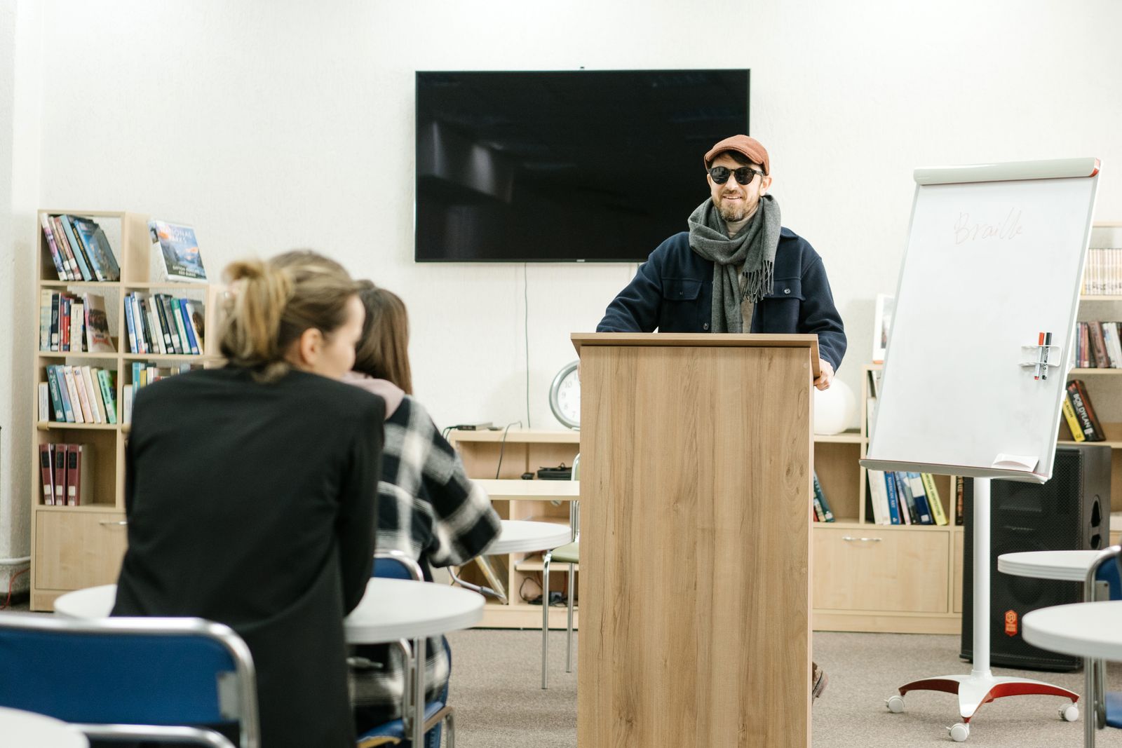 Presenter leading an inclusive classroom session in a library setting.