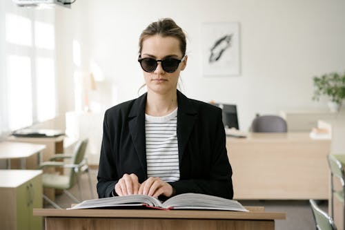 Woman in Black Coat using Braille