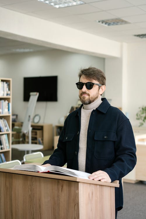 Man in Black Coat using Braille