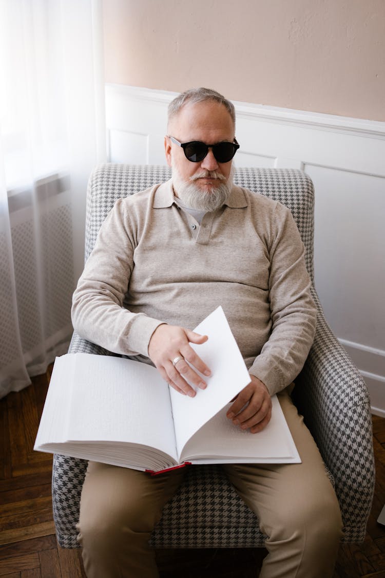 A Blind Man Sitting On A Chair 