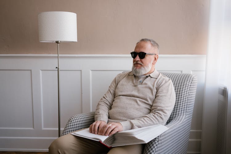 A Blind Man Sitting On A Chair 