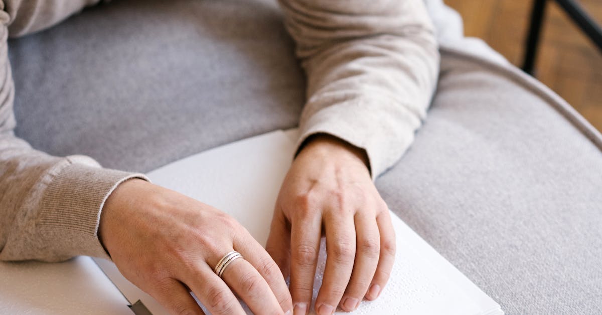 Man in Gray Sweater Writing on White Paper