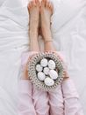 Woman Holding Gray Crochet Bowl With Seven Painted Eggs