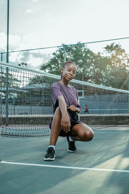 Free Young Woman Posing on a Tennis Court  Stock Photo