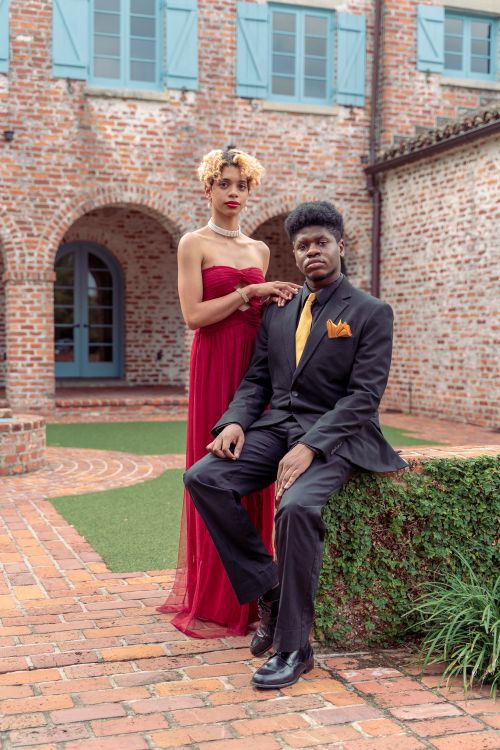 Woman in Red Dress and Man in Black Suit with Yellow Tie  Free Stock Photo