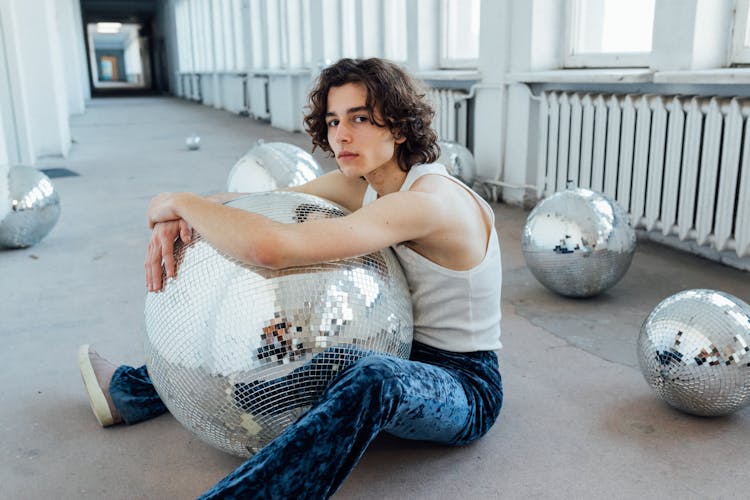 A Man Hugging A Disco Ball