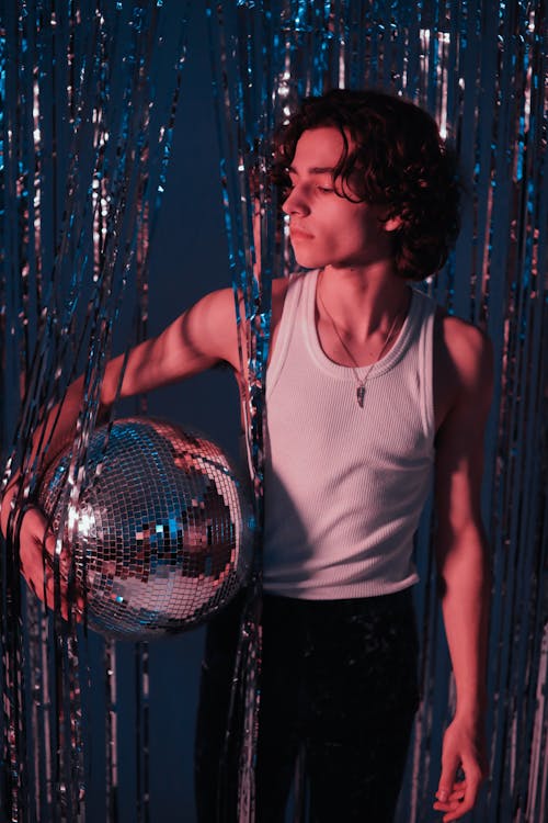 A Man Holding a Disco Ball