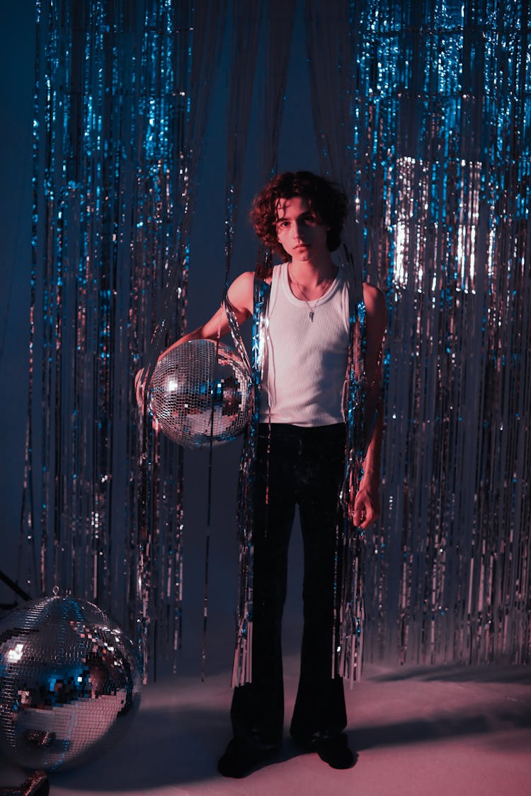 A Man Holding Disco Ball