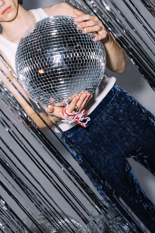 A Man Holding a Disco Ball