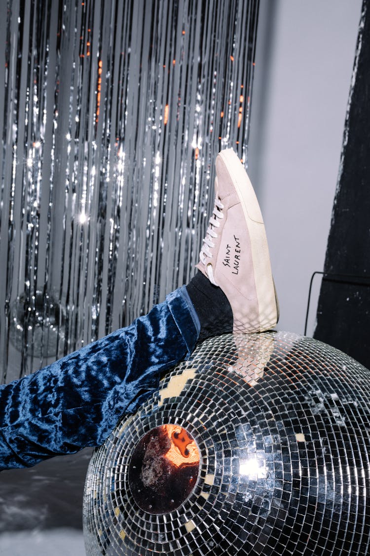 A Person's Foot On A Disco Ball