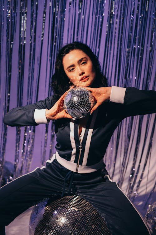 Woman in Black Blazer Holding Silver Ball