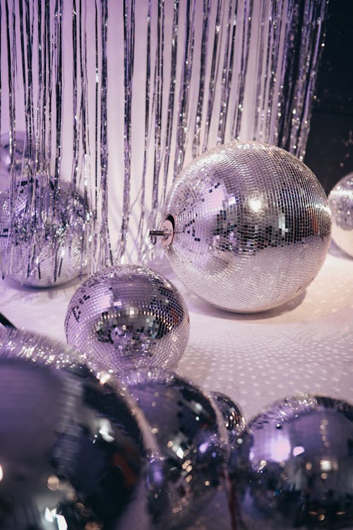 Free Silver and Purple Baubles on White Textile Stock Photo