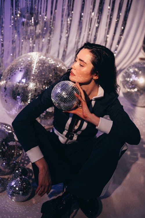 Beautiful Woman Holding Disco Balls