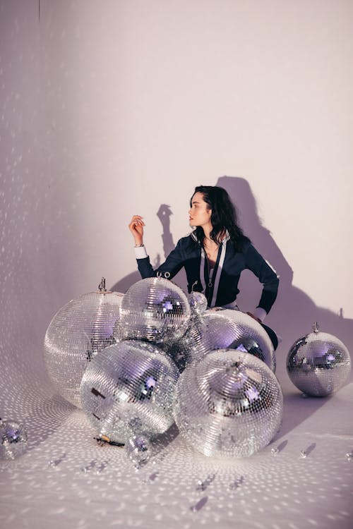 Woman Posing Near Mirror Balls