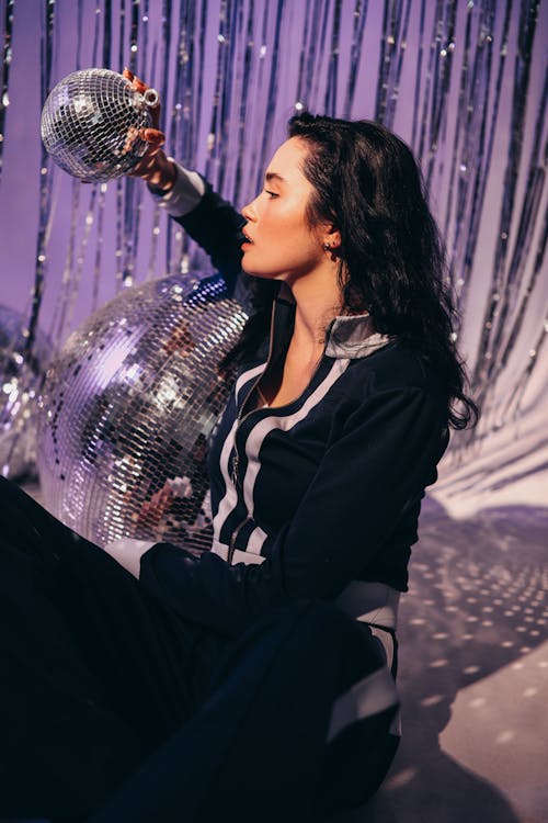 Woman Holding a Disco Ball